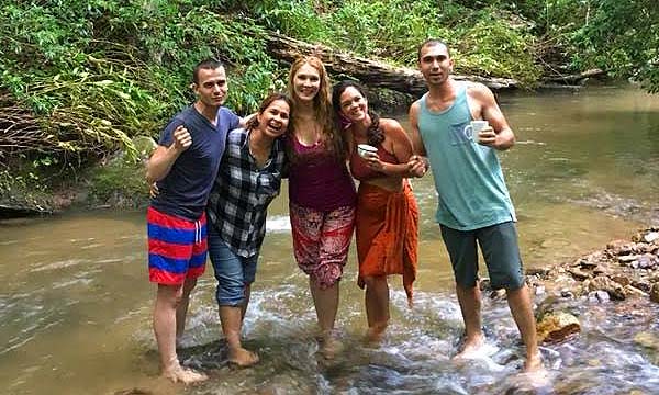 Five friends enjoying walking in the creek at Earthaven Ecovillage
