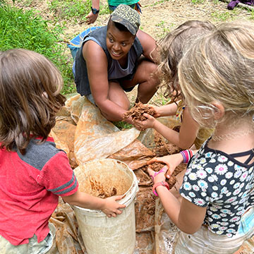 kids making cob at Earthaven Ecovillage