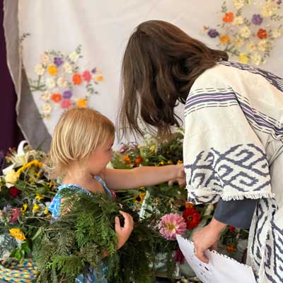 Putting flowers on a body before a funeral